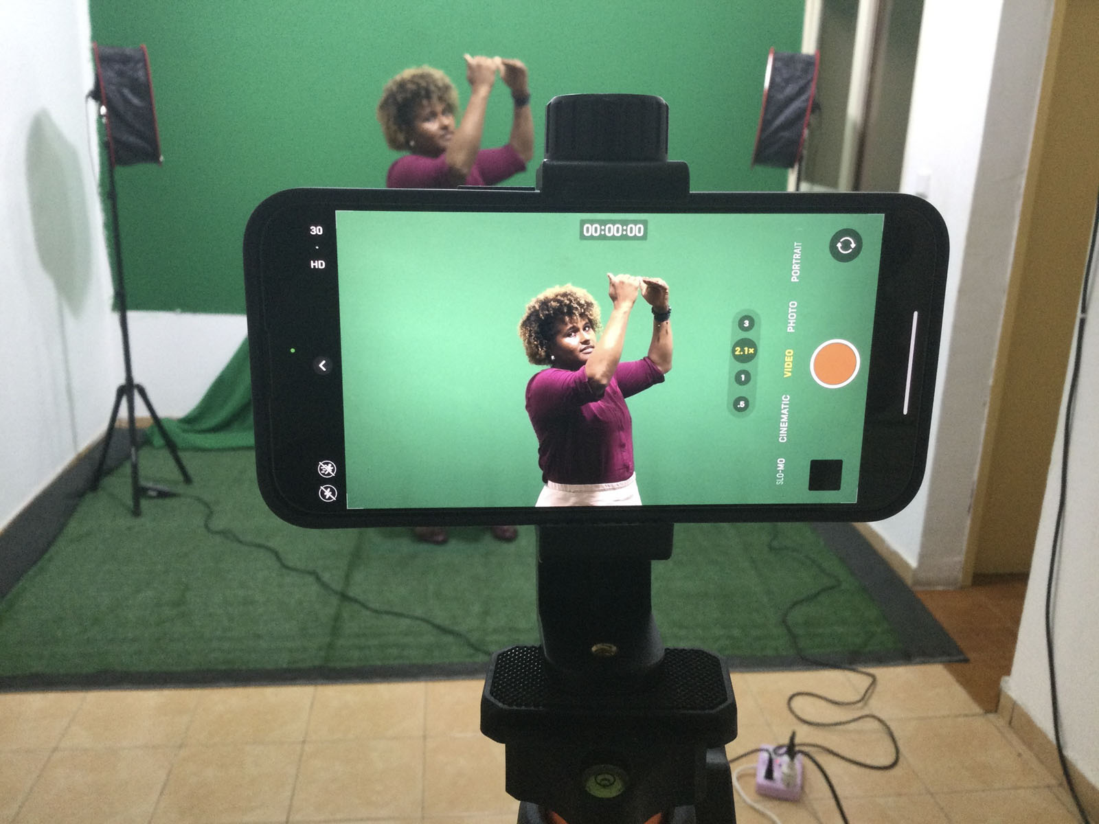 Woman recording in front of green screen